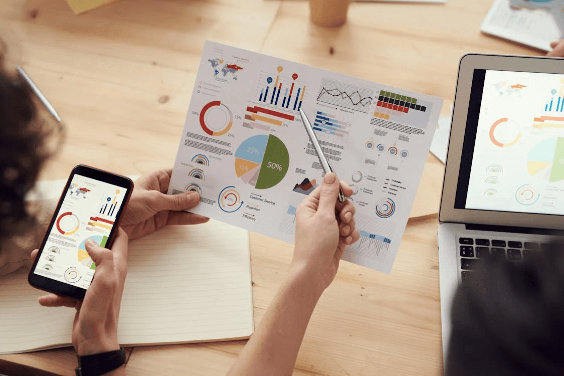 Charts and figures being read across a desk