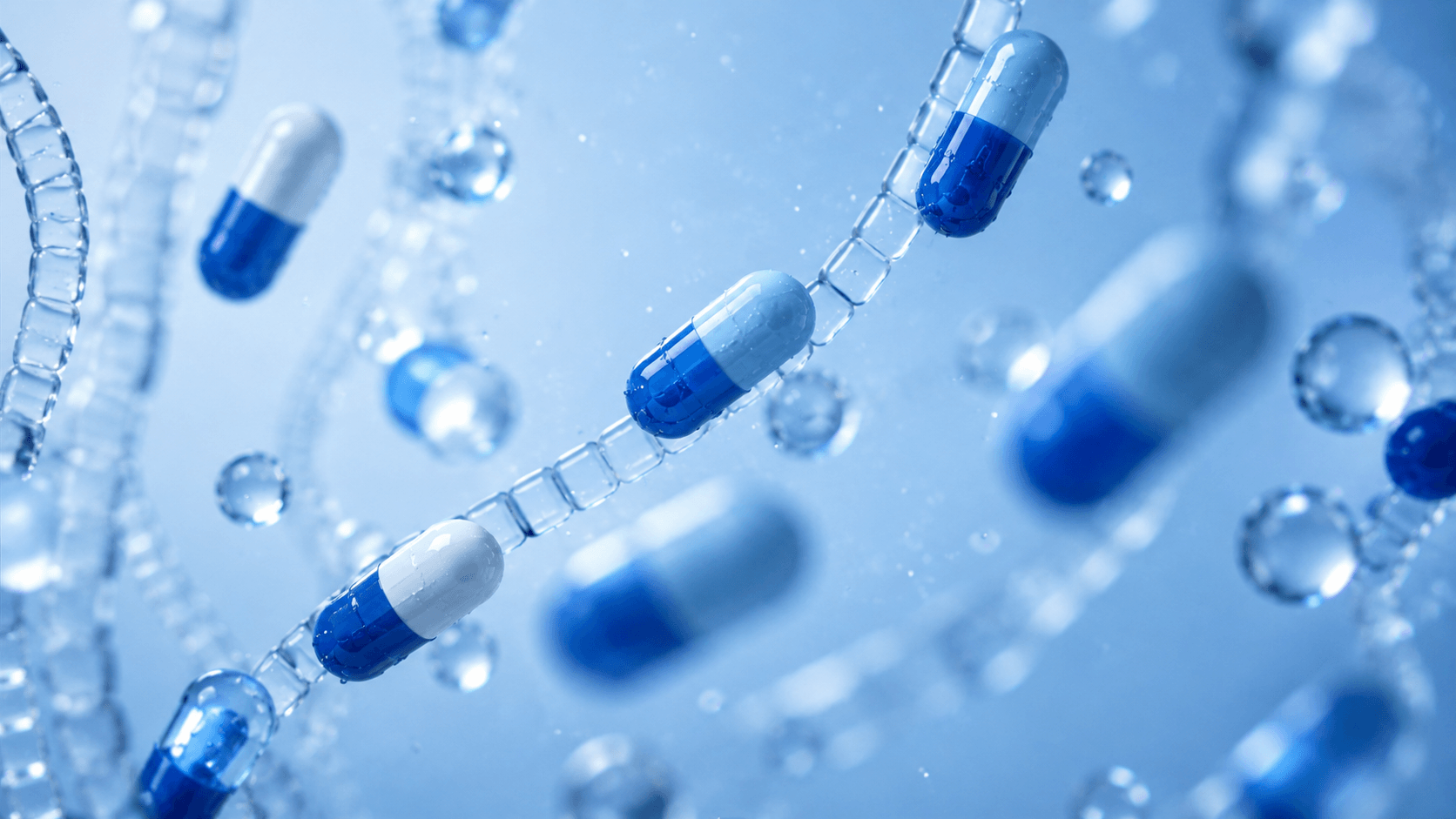 Blue and white pharmaceutical capsules suspended in water